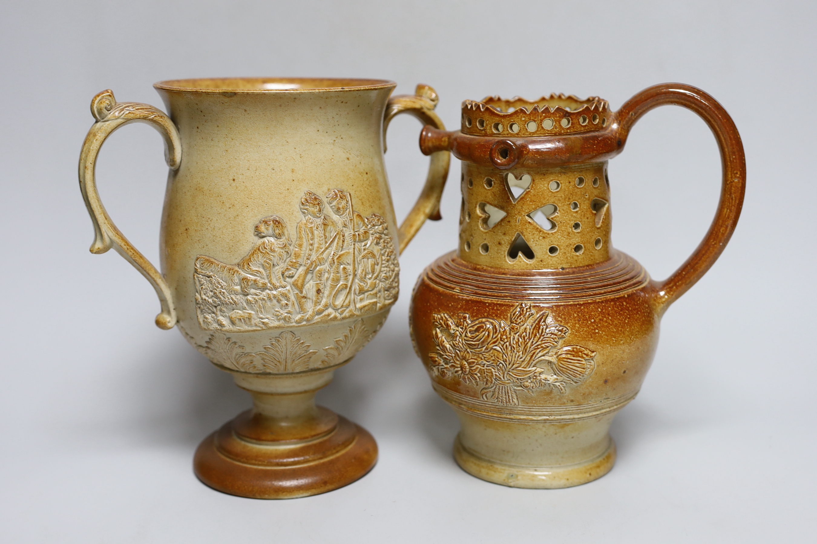 A Brampton salt glazed stoneware puzzle jug and a similar two handled loving cup, c.1840, tallest 21cm
